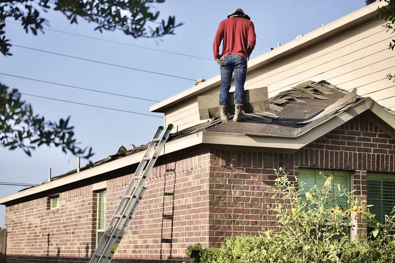 Professional roofer working on a residential roof in Towne Place